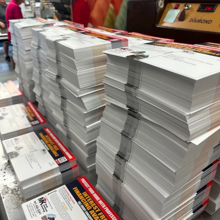 Stacks of bundled direct mail flyers ready for distribution from Punta Gorda.